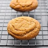 Square shot of old fashioned chewy molasses cookies on a cooling rack.
