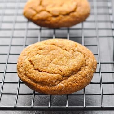 Square shot of old fashioned chewy molasses cookies on a cooling rack.