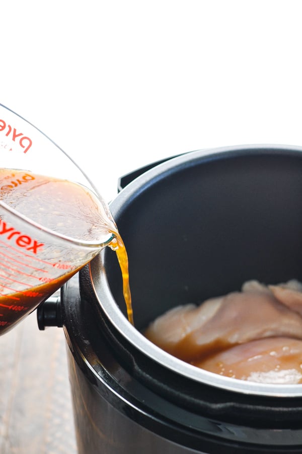 Teriyaki chicken sauce poured over raw meat