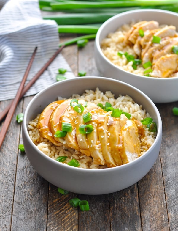 Front view of sliced teriyaki chicken in a bowl of rice