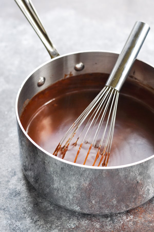Chocolate pudding pie filling in saucepan with whisk