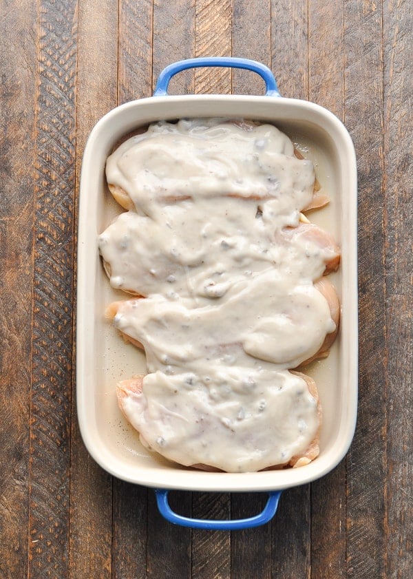 Overhead shot of raw chicken breasts with mushroom soup on top