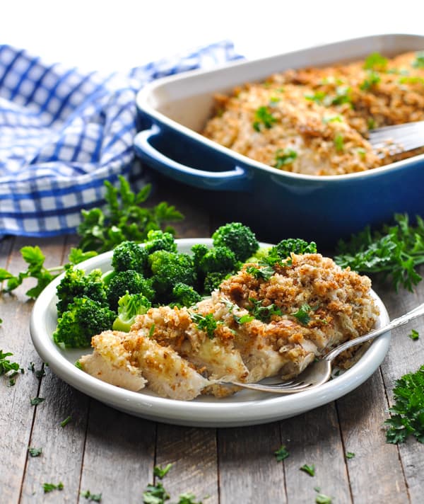Chicken stuffing casserole on white plate with broccoli