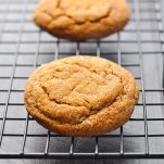 Soft and thick chewy molasses cookies on a wire rack.