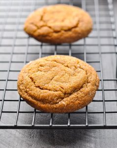 Soft and thick chewy molasses cookies on a wire rack.