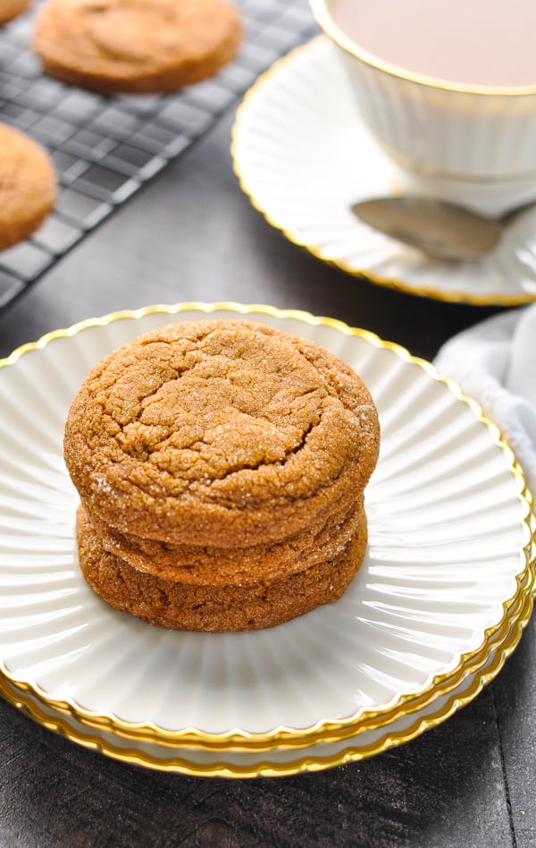 Stack of three soft molasses cookies on china plate