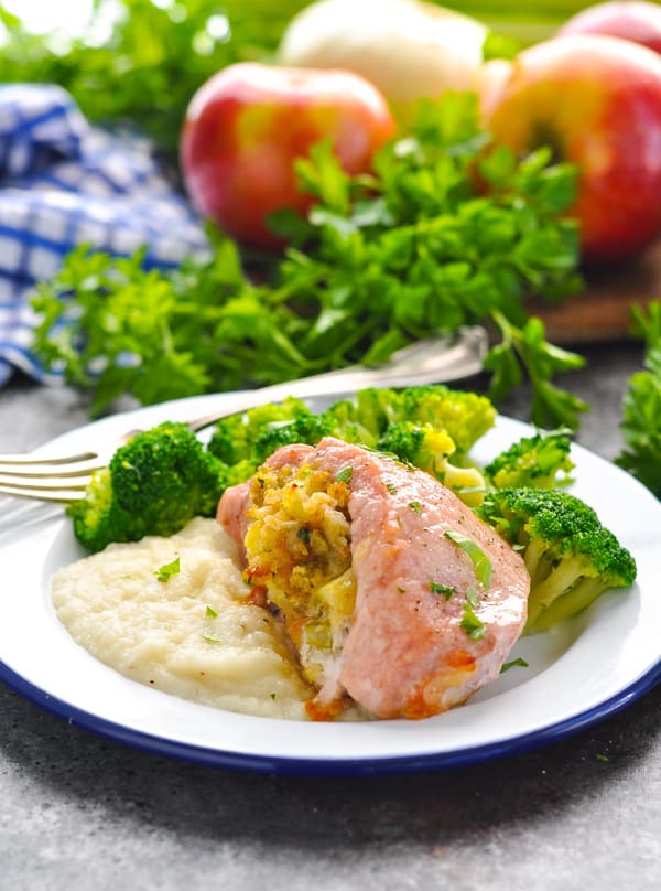 Easy baked boneless stuffed pork chops on a plate with broccoli and mashed cauliflower