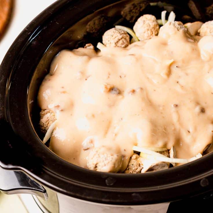Process shot showing how to make meatball stroganoff in a slow cooker.