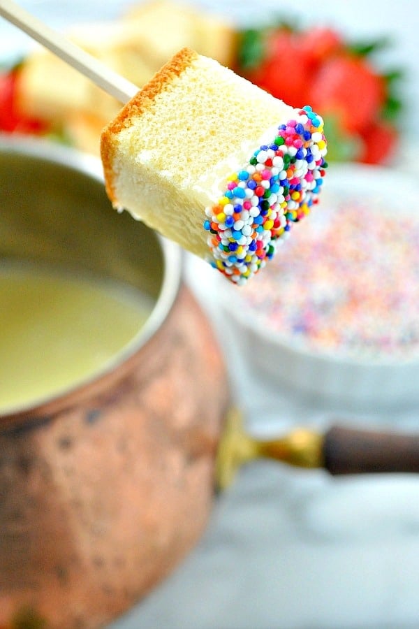 Pound cake on a stick dipped in white chocolate fondue
