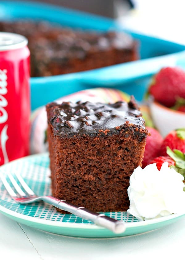 Coca Cola Cake on a plate with whipped cream