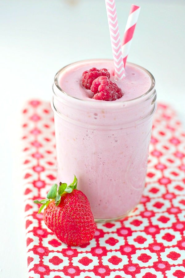 Front view of Vanilla Berry Smoothie in a mason jar with fresh berries on top