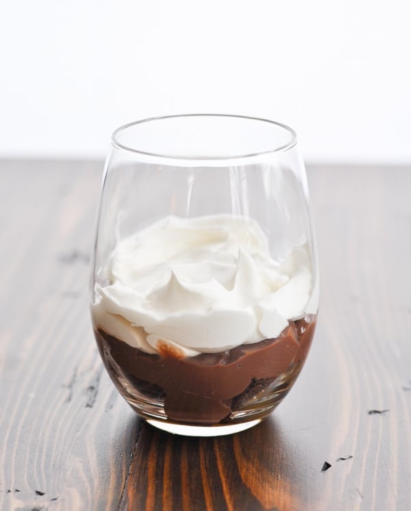 Layer of whipped topping in a chocolate trifle glass