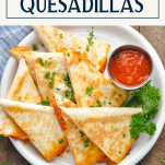 Overhead shot of a plate of pizza quesadillas with text title box at top
