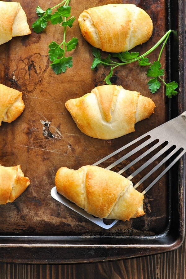 Roast beef and cheese stuffed crescent rolls over head shot on a baking sheet