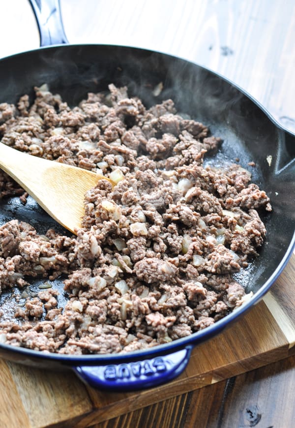 Browned ground beef and onion in a large cast iron skillet