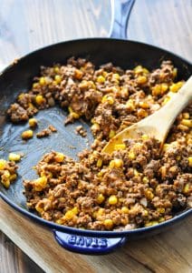 Ground beef taco filling in a skillet for stuffed potatoes