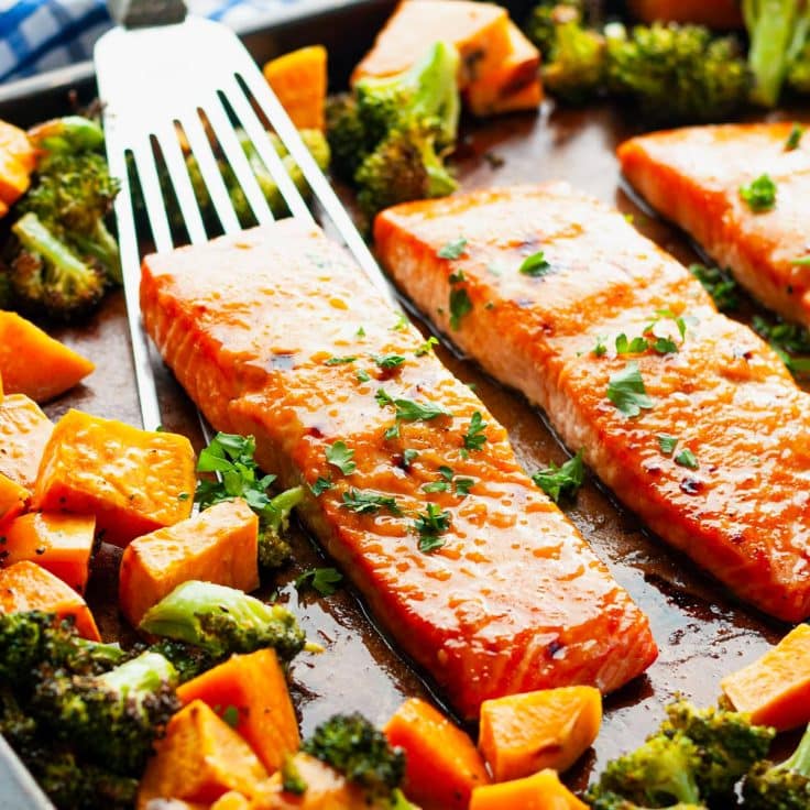 Square side shot of sheet pan salmon with broccoli and sweet potatoes.