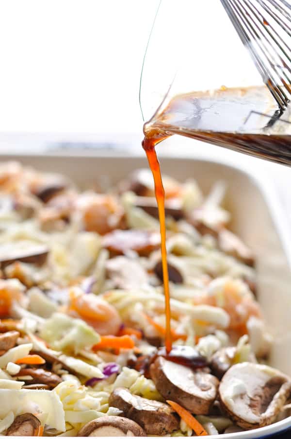 Pouring moo shu sauce over ingredients in baking dish