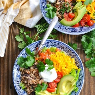 Overhead shot of two rice and bean vegetarian burrito bowls