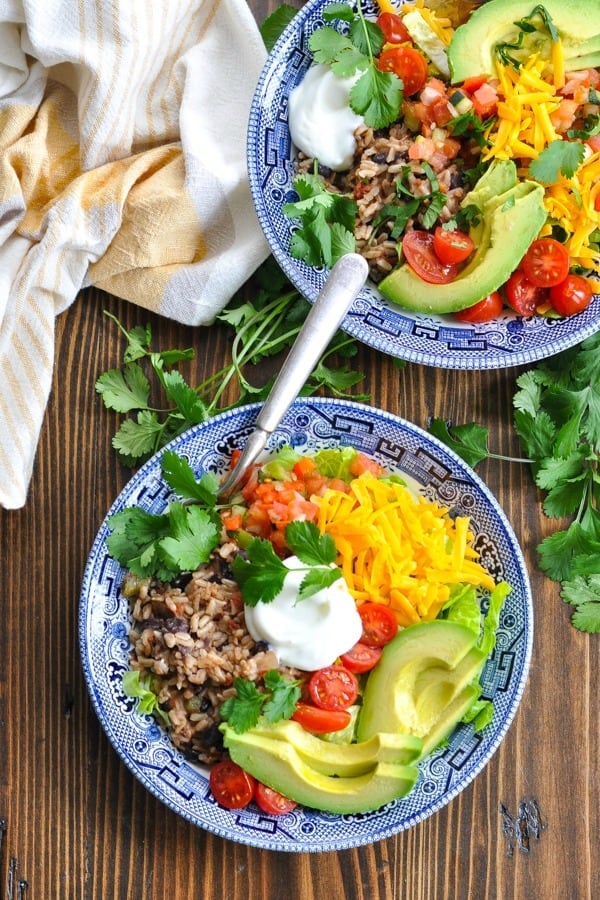 Overhead shot of two rice and bean vegetarian burrito bowls