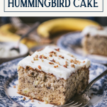 Slice of hummingbird cake on a plate with text title box at top