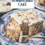 Side shot of a slice of hummingbird cake with a bite on a fork with text title overlay