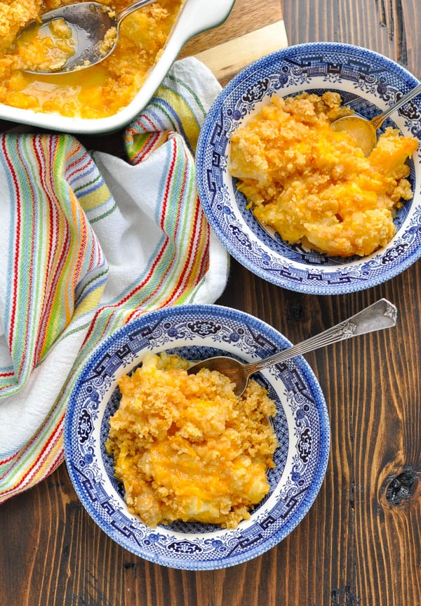 Overhead shot of Southern Pineapple Casserole in bowls with a striped towel on the table