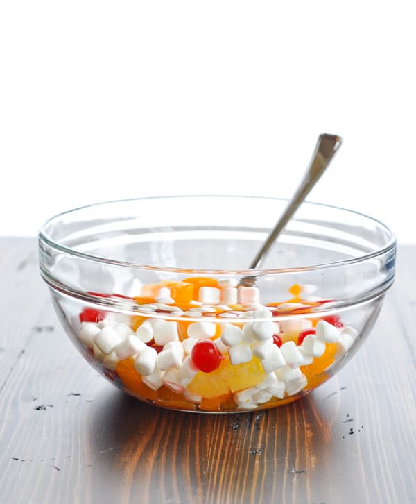 Fruit and marshmallows in a glass mixing bowl