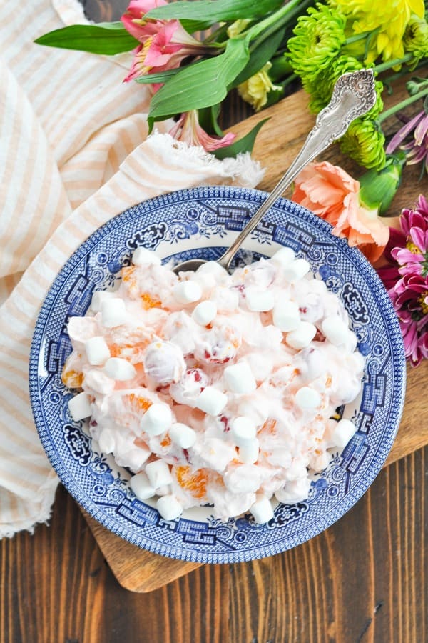Overhead shot of pink ambrosia salad surrounded by flowers