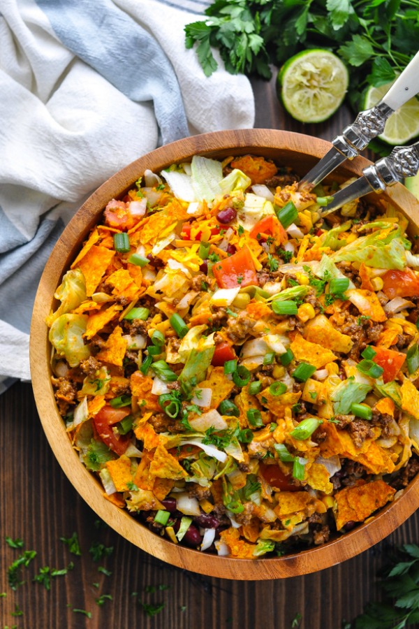 Close up shot of taco salad in a wooden serving bowl
