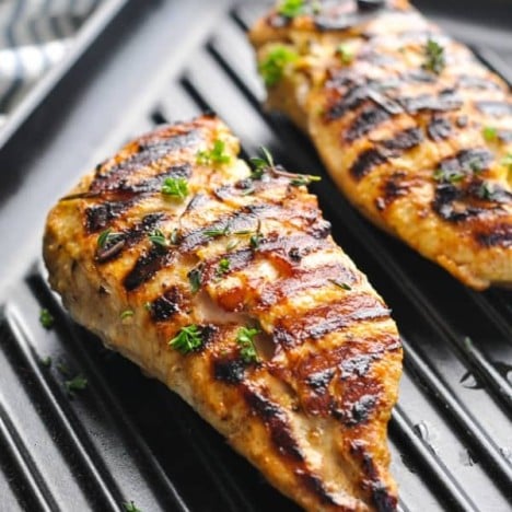 Close up shot of marinated chicken on a grill pan