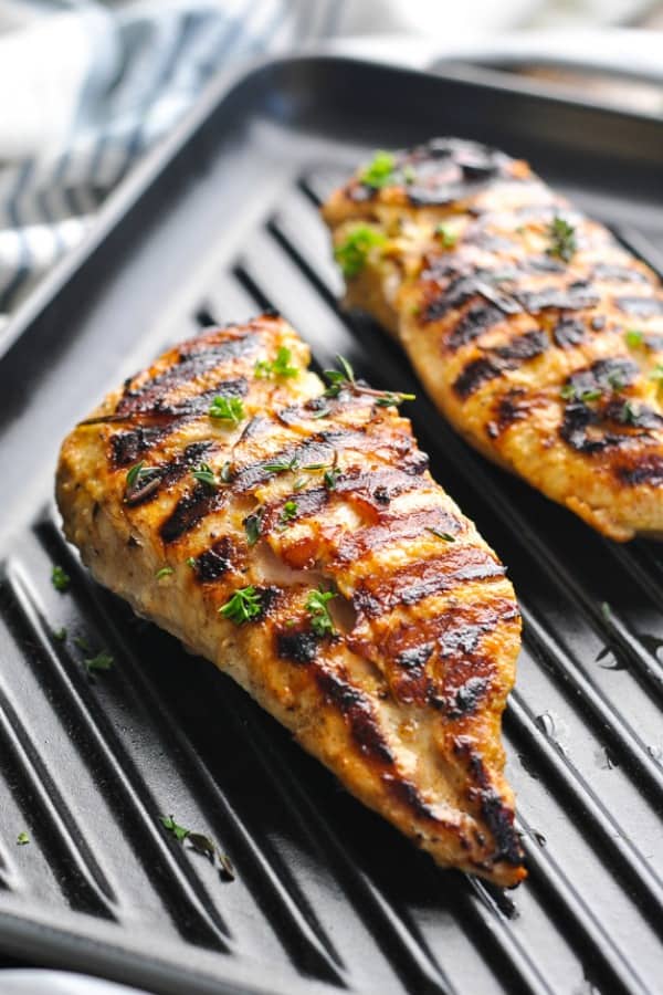 Close up shot of marinated chicken on a grill pan