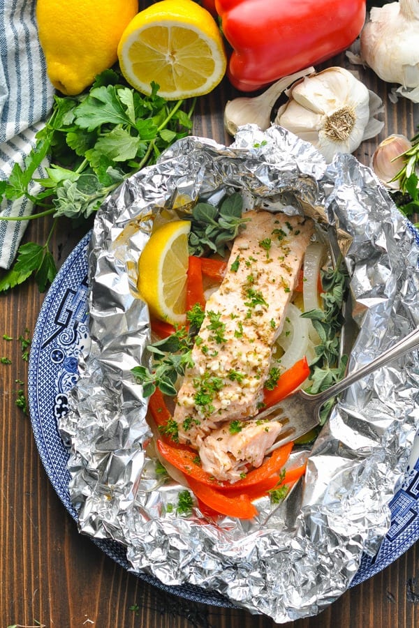 Overhead shot of foil pack salmon on a plate with a fork