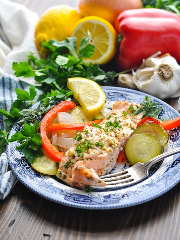 Salmon with a fork on a plate with fresh lemon