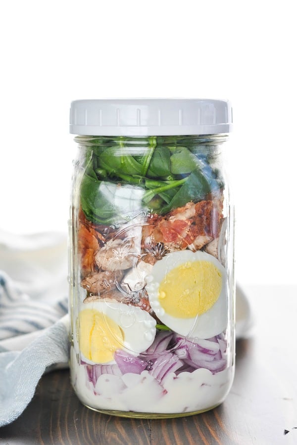 Spinach Salad with bacon in a mason jar