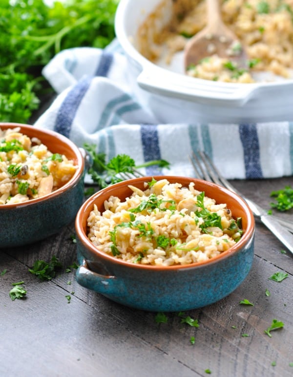Bowls of rice pilaf with a white casserole dish in the background