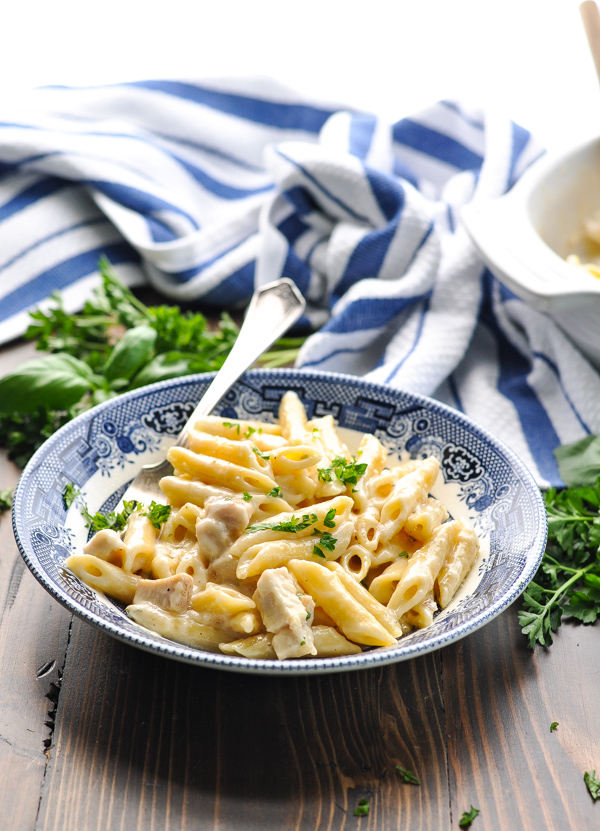 Front shot of Parmesan Penne Pasta with chicken in a blue and white bowl