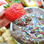 Dipping strawberry in chocolate cake batter dip