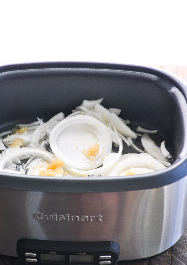 Garlic and onions in bottom of slow cooker