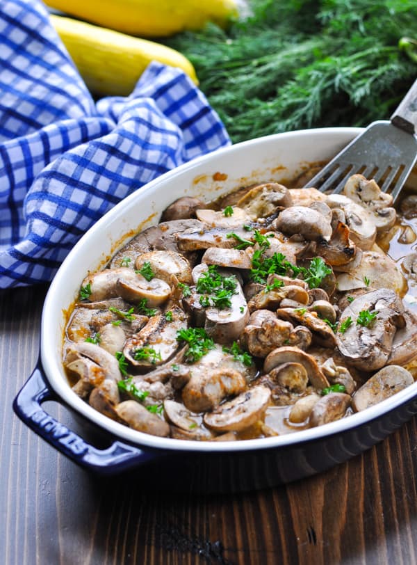 Baked chicken and mushrooms in a blue baking dish