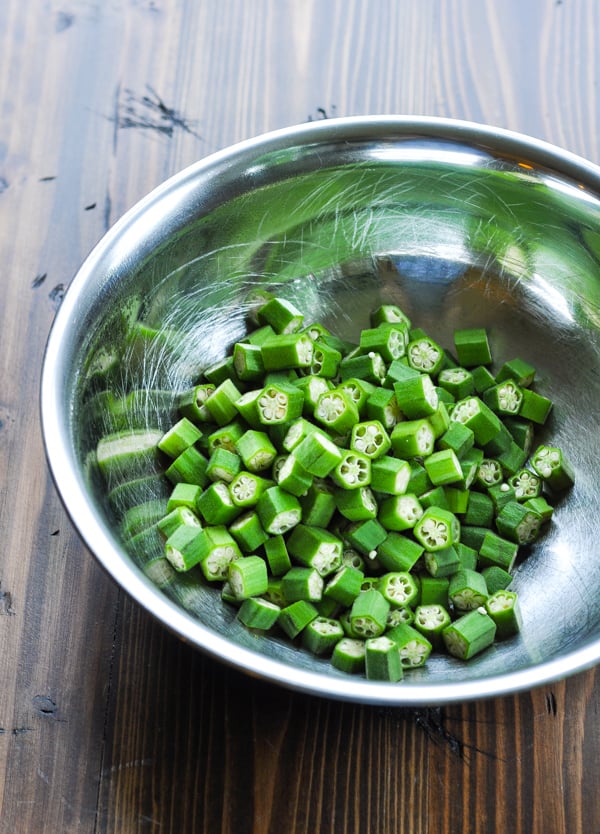 Cut fresh okra in a stainless steel bowl