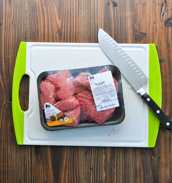 Overhead shot of sirloin steak in package on a cutting board