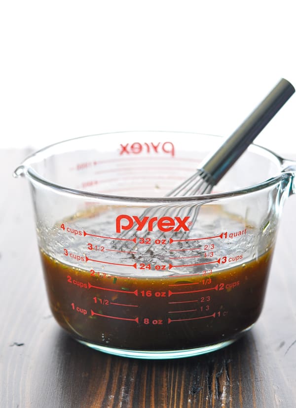 Chicken breast marinade in a glass measuring cup