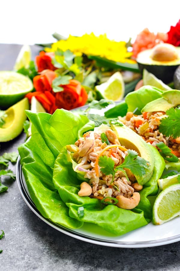Front shot of lettuce wraps on a white plate with black trim