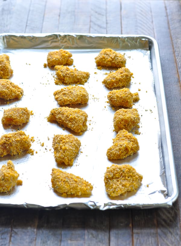 Homemade chicken nuggets on baking sheet before the oven