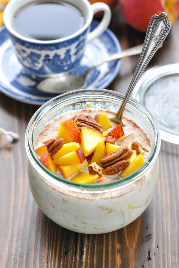 Fresh peaches stirred into a bowl of overnight oatmeal