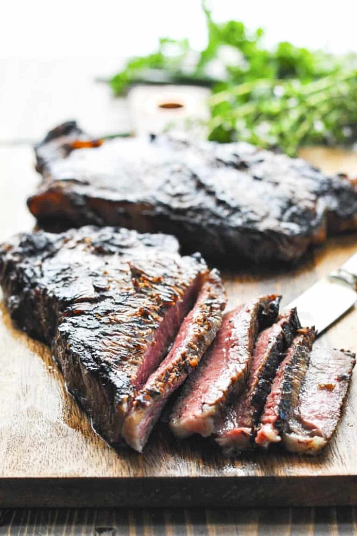 The best simple steak marinade for grilling on New York strips that have been grilled.
