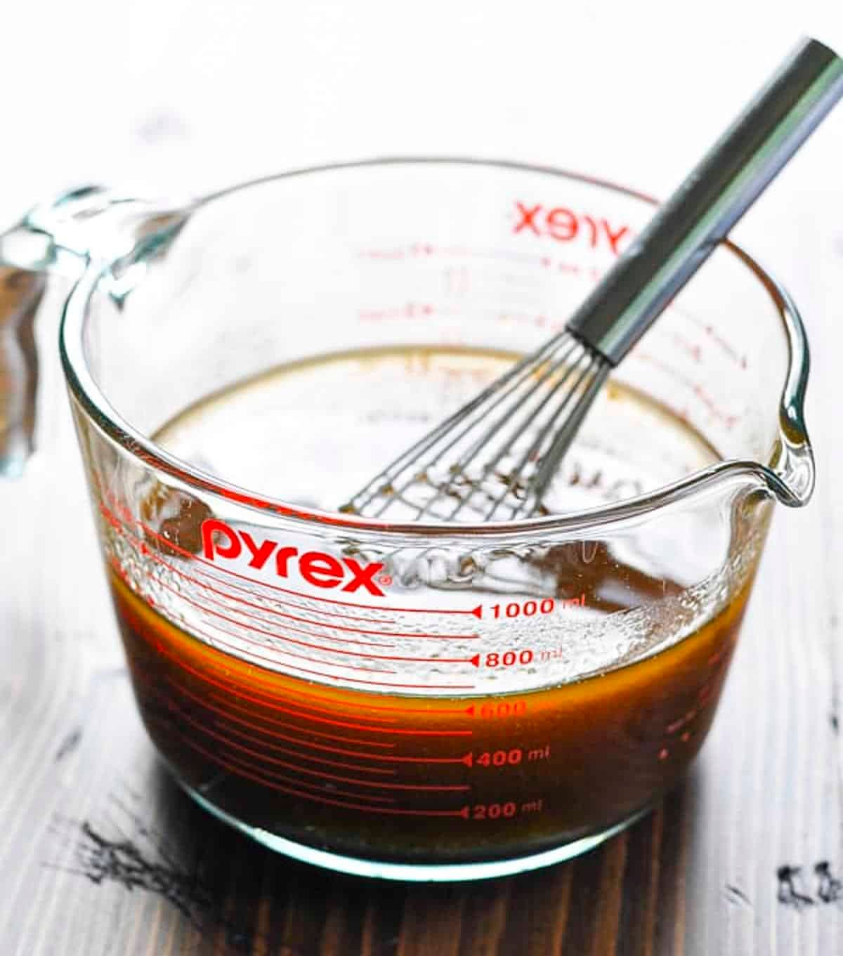 A simple steak marinade for grilling in a glass measuring cup.