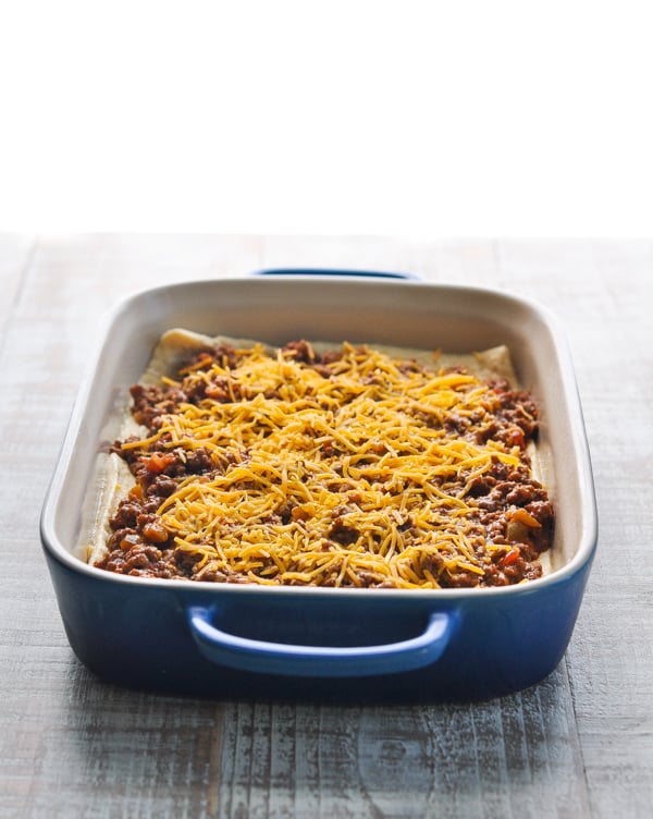 Taco casserole in a blue baking dish before oven
