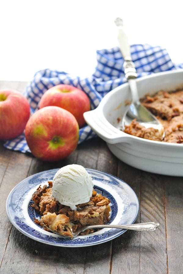 Apple dump cake on a plate with cake in pan in background